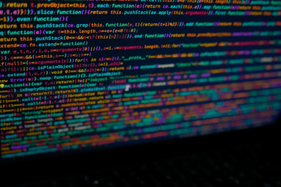 Minified JavaScript source code shown in colour on a dark screen at an angle