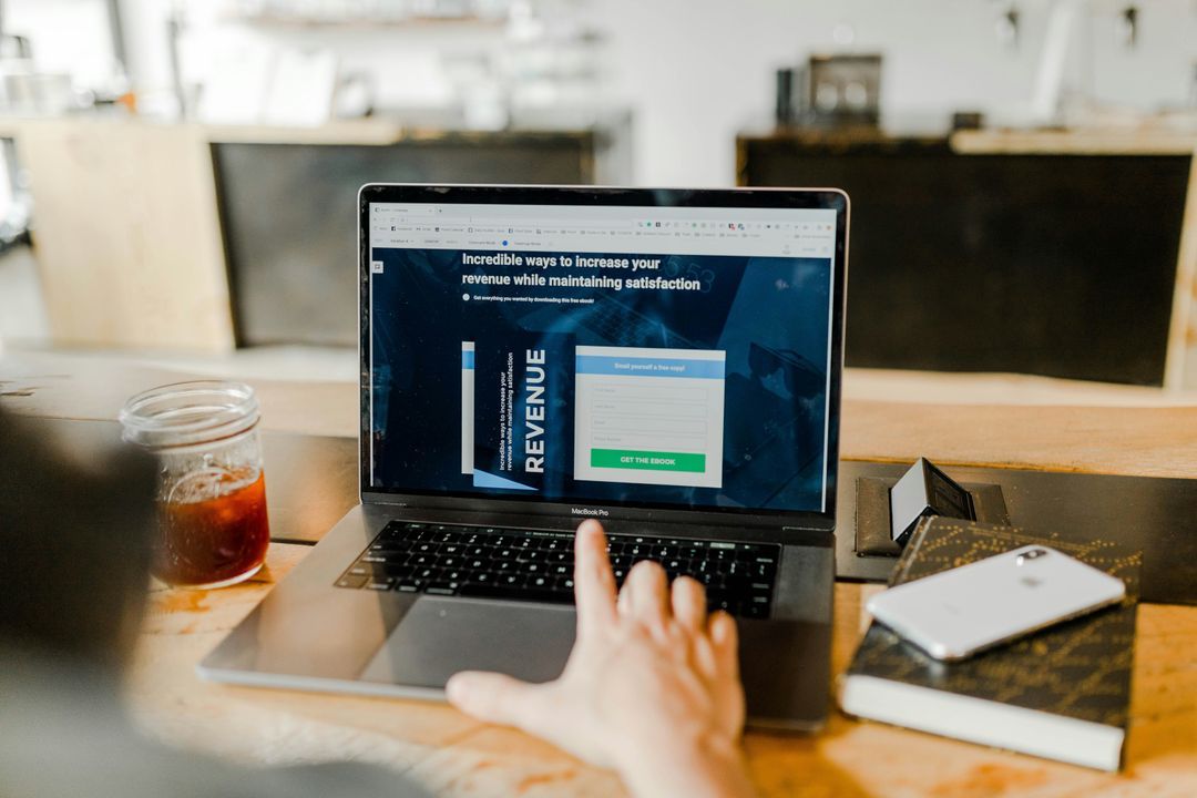Person at a laptop viewing a marketing landing page with an ebook sign-up form